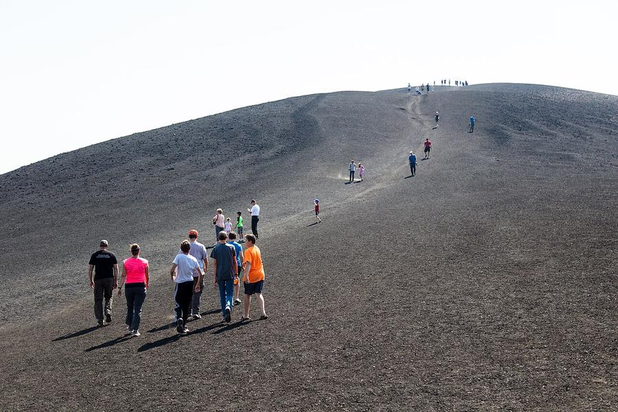 Hikers on Inferno Cone at Craters of the Moon National Monument, Idaho